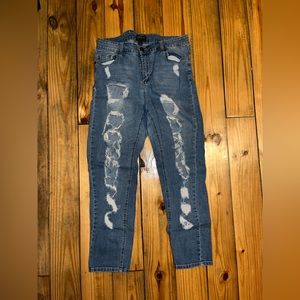 Highly distressed blue jeans